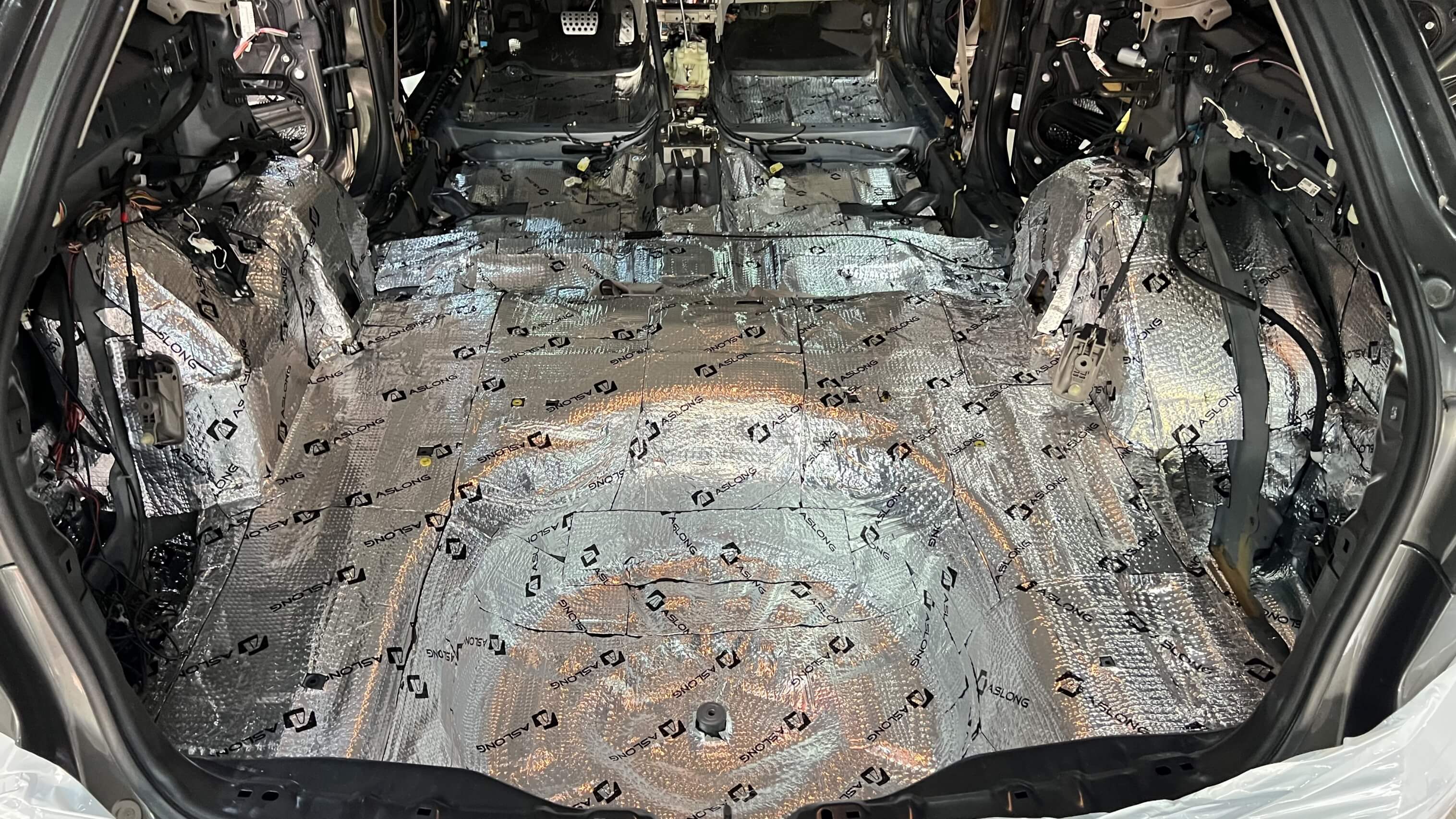 Interior of a car stripped and lined with sound dampening material. Interior of a car stripped and lined with sound dampening material.