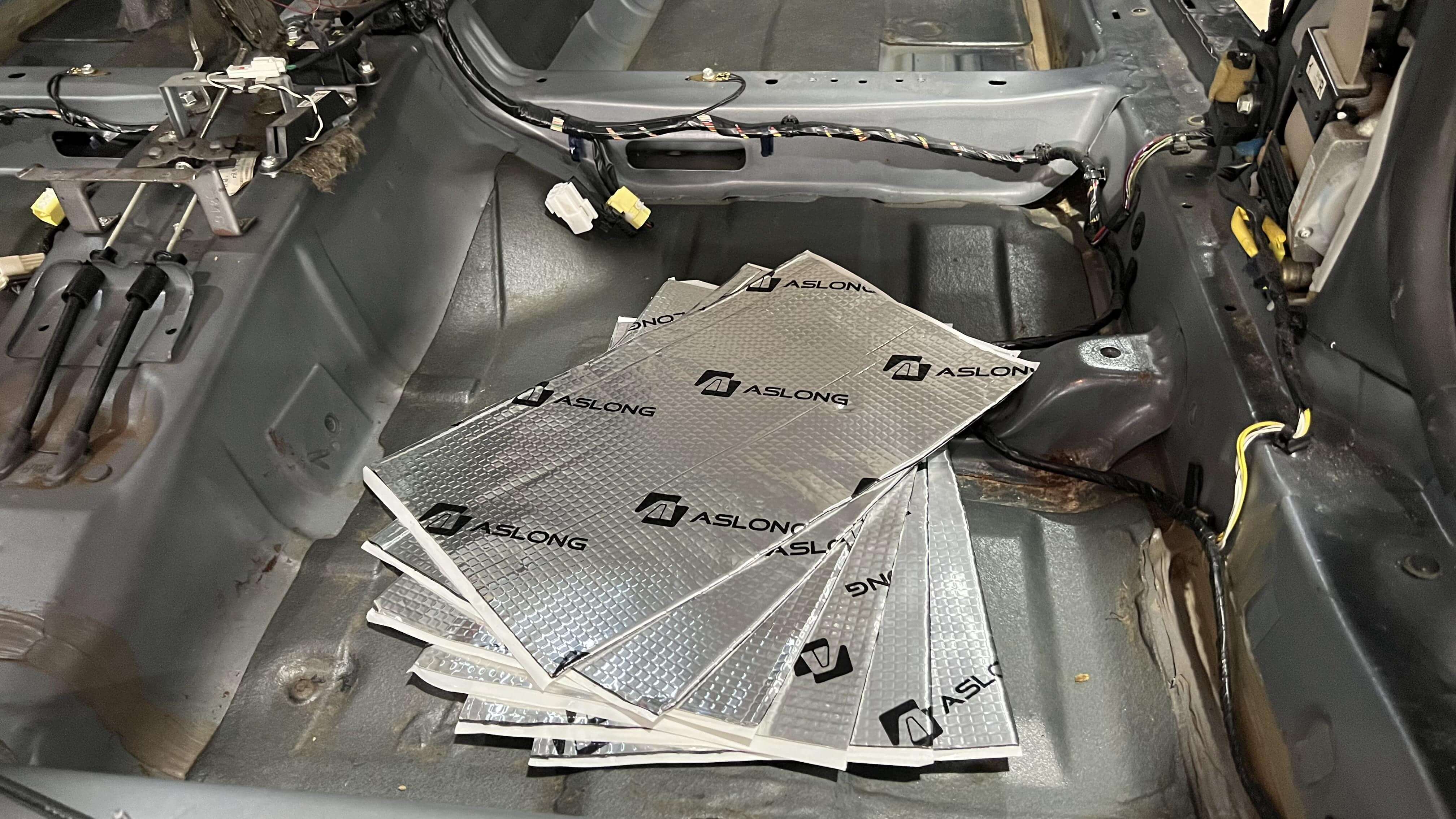 Bare car interior with Aslong sound dampening mats.