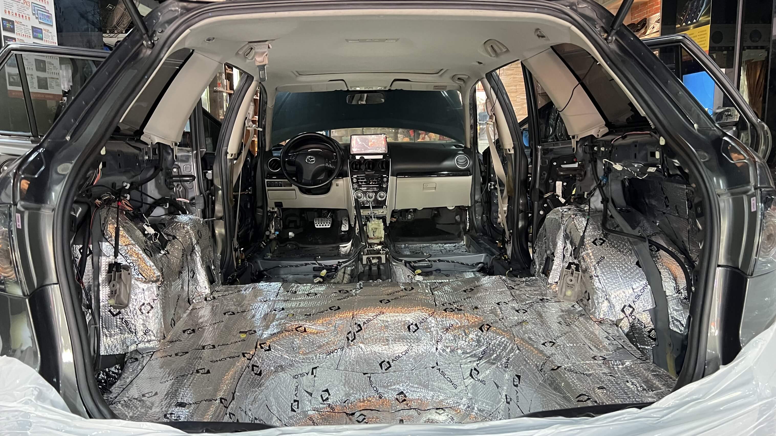 Car interior stripped and lined with sound dampening material. Car interior stripped and lined with sound dampening material.