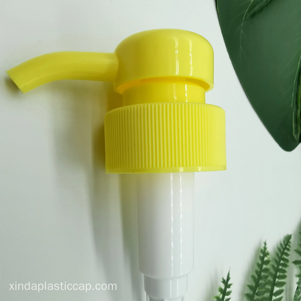 A yellow plastic pump dispenser with a ribbed neck and a long curved nozzle.