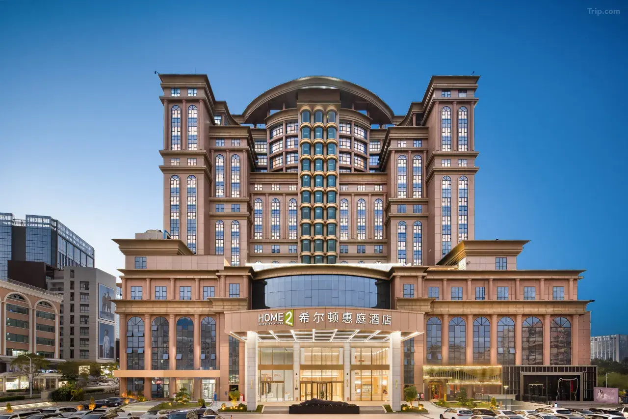Exterior view of the Home2 Suites by Hilton hotel building at dusk.