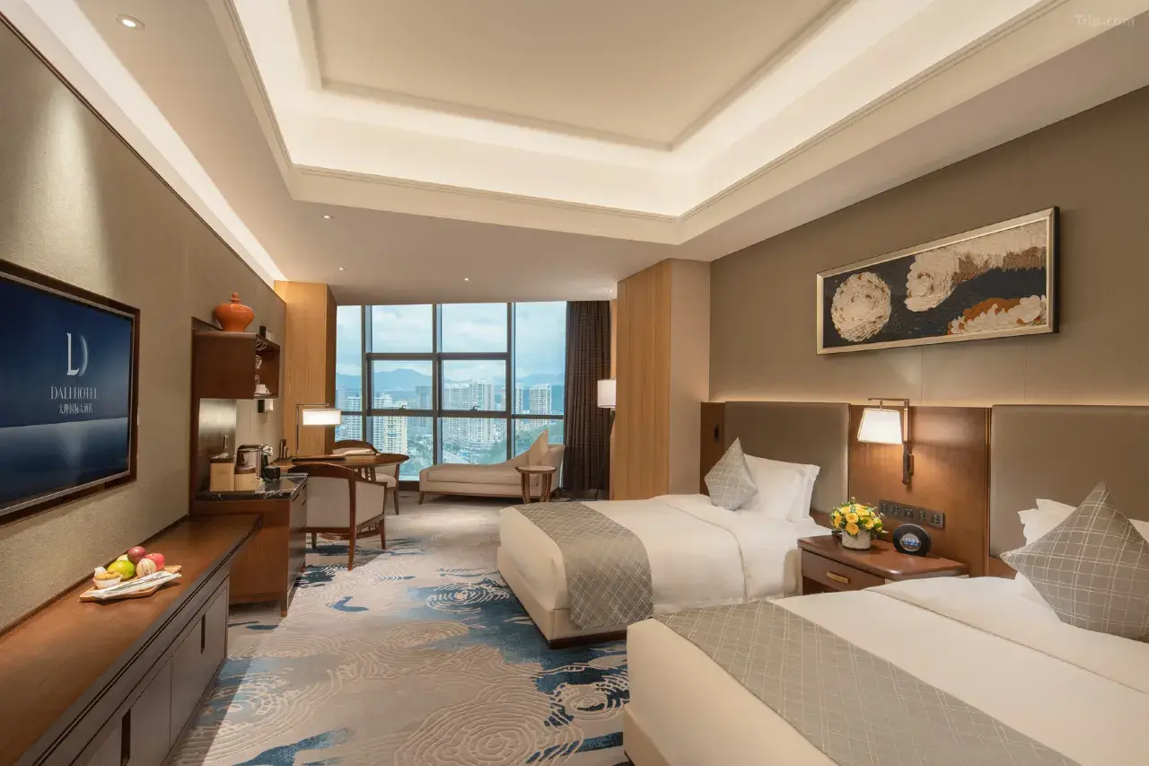Modern hotel room with two twin beds, a large window, and city views.
