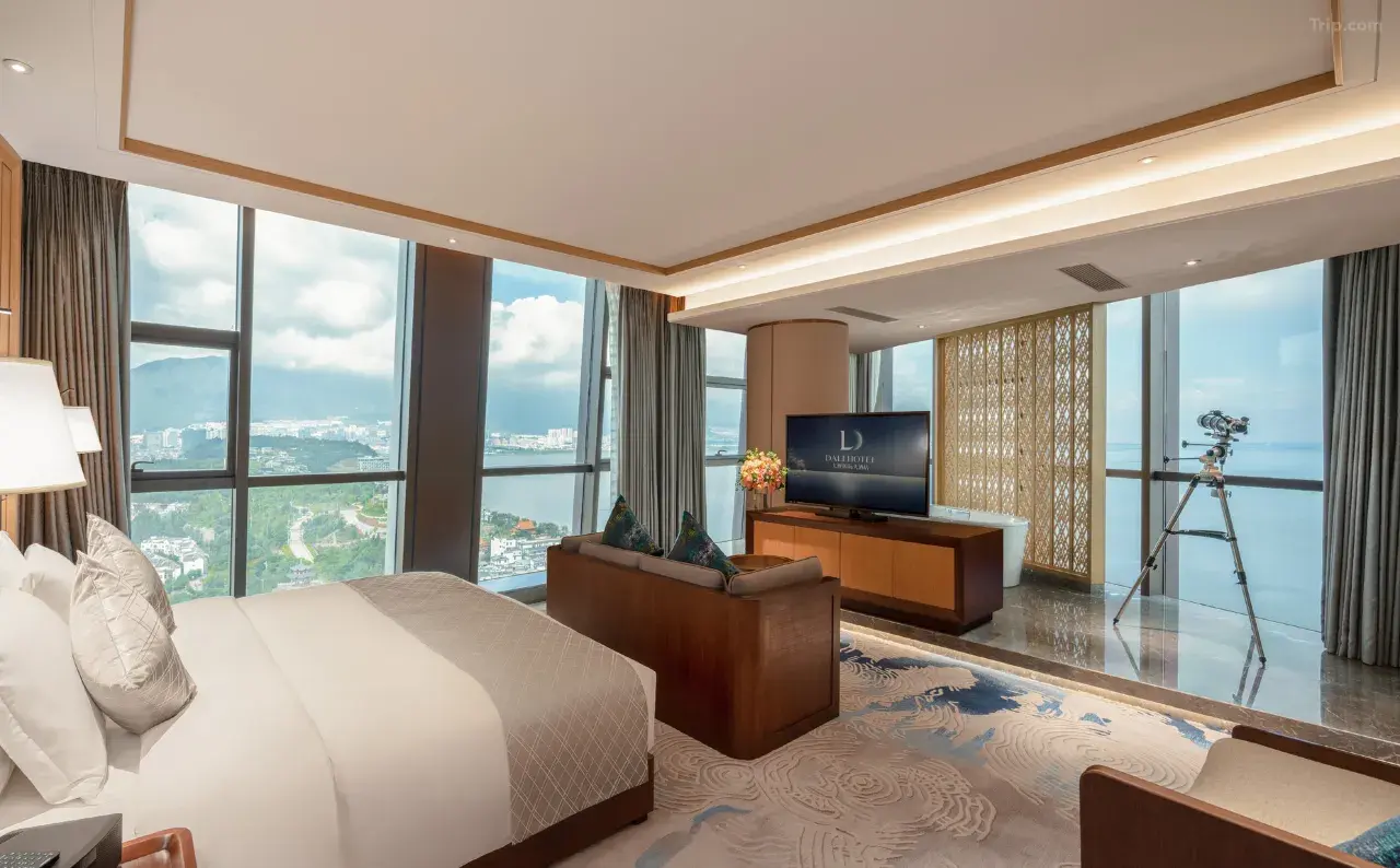 Modern luxury hotel suite with floor-to-ceiling city and lake views.