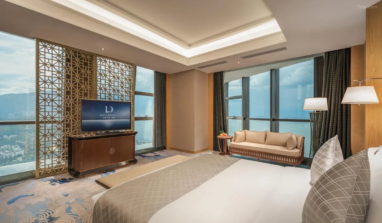 Modern luxury hotel room with floor-to-ceiling windows and a mountain view.