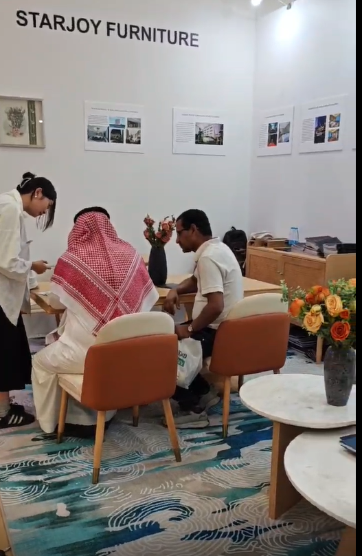 Starjoy Furniture booth with visitors.