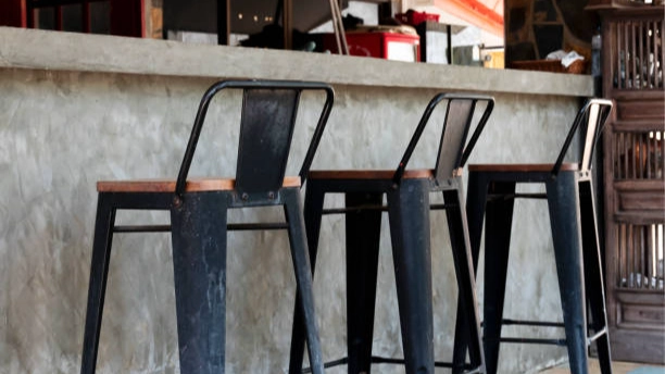 Custom hotel mini bar with three stools.