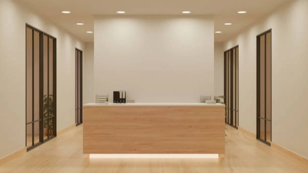 Modern hotel reception desk design with light wood.