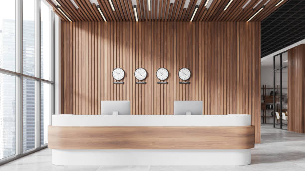 Modern hotel reception desk with wood paneling.