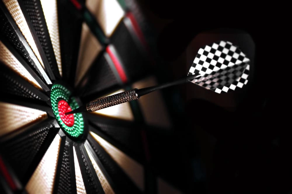 WillDarts - Dart with checkered flight stuck in the bullseye.