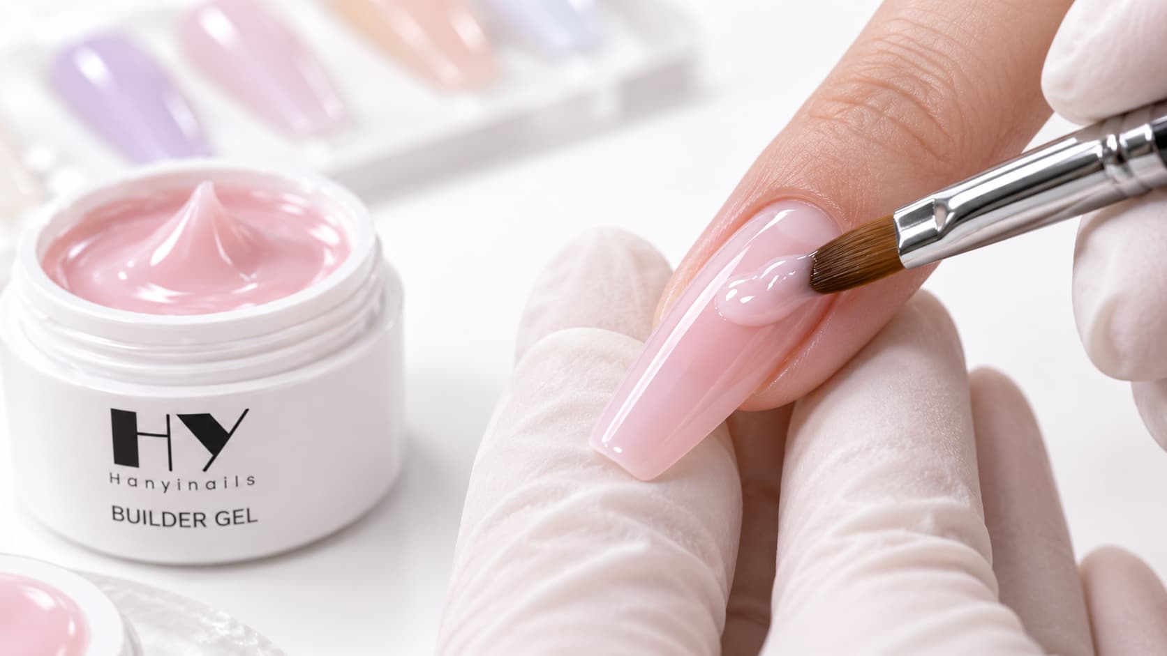 Colored builder gel being applied with a builder gel brush to build controlled structure on a spring nail extension with a clean cuticle area