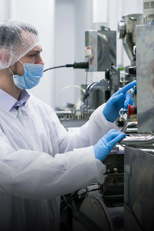 worker-factory-white-suit-working-with-manufacture-machine_645730-238