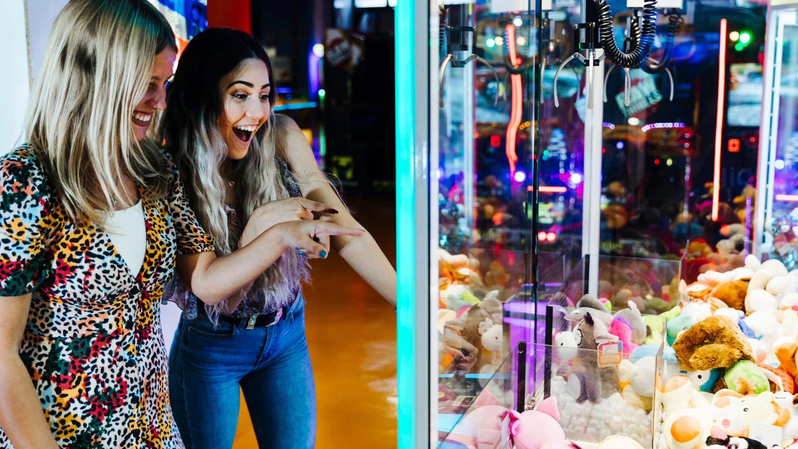 happy-women-playing-arcade-machine_23-2148253122