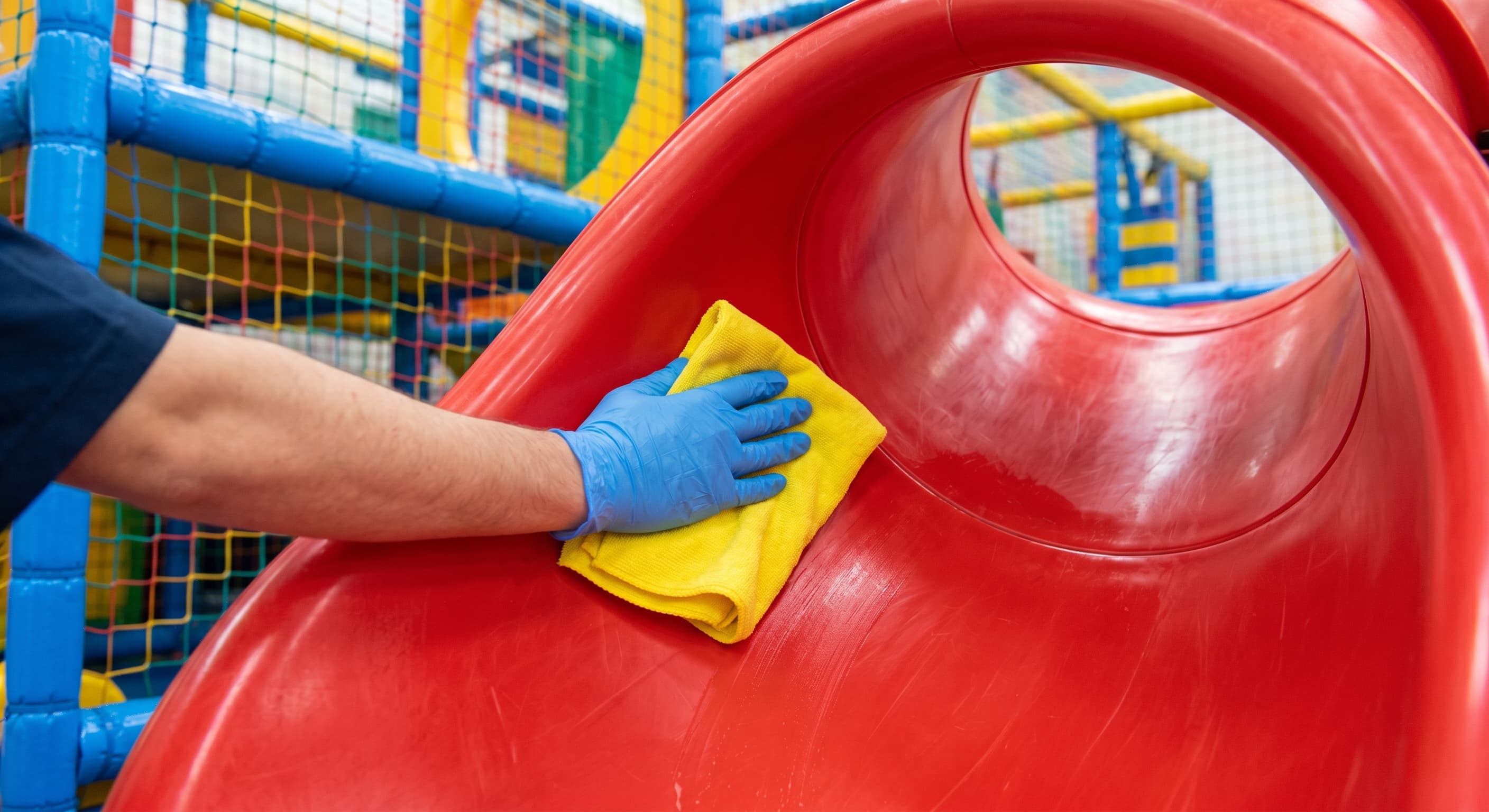 Step-by-step cleaning indoor playground equipment plastic slide surfaces.