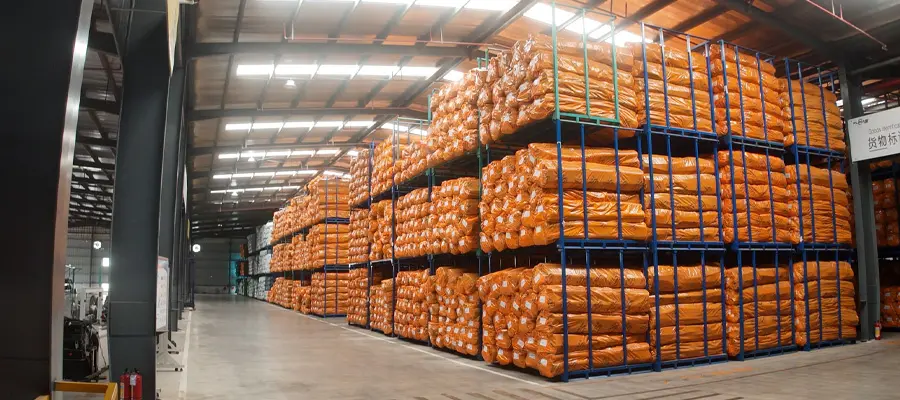 Packaged insulation materials stored on racks in the FUNAS factory warehouse - FUNAS