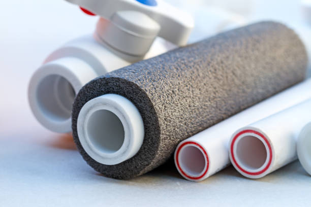 Close-up of insulated plumbing pipes and a white valve.