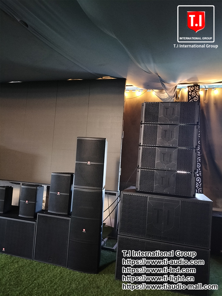 T.I Kenya Showroom A collection of T.I International Group line array speakers and subwoofers set up in a dark room.