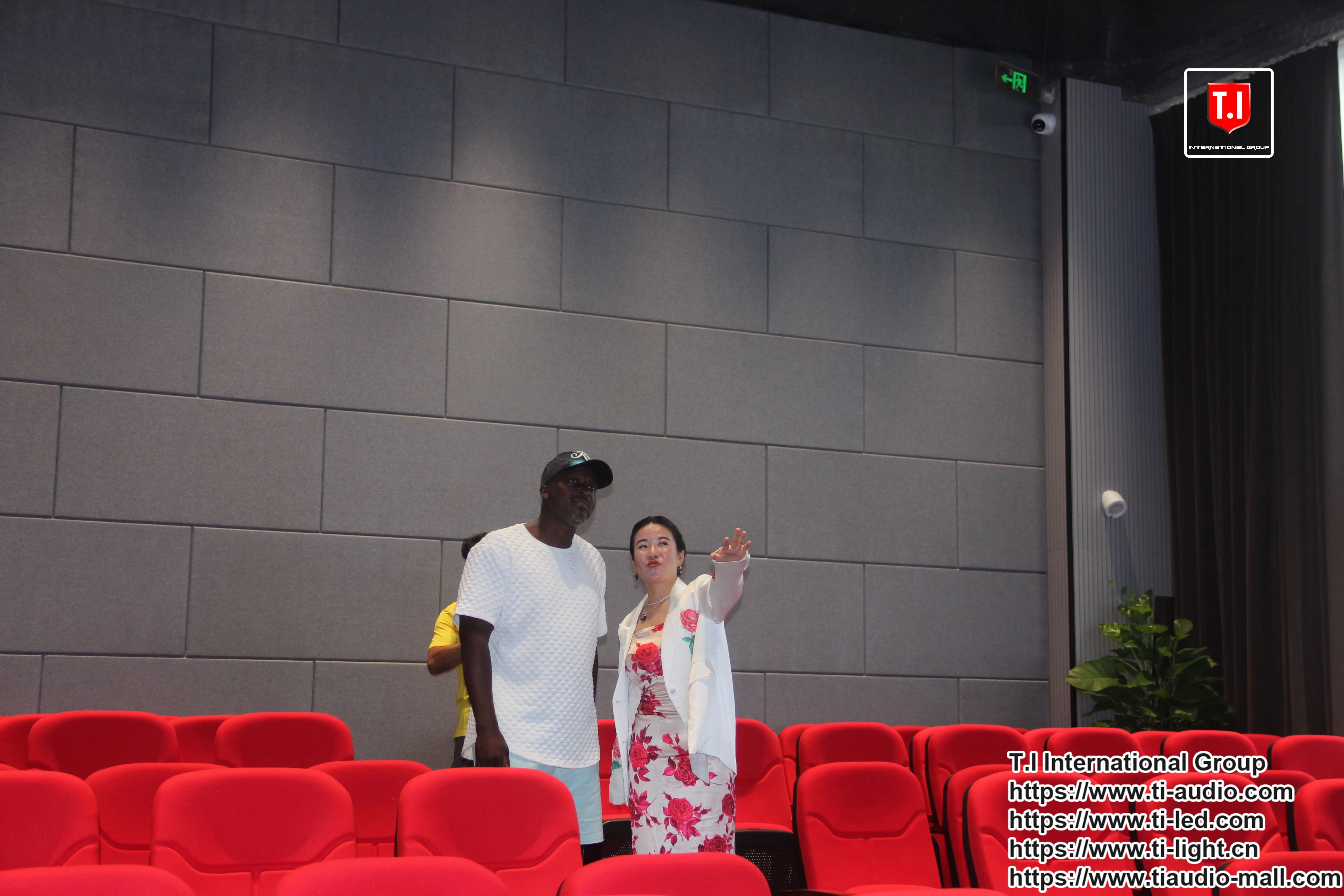 People in a theater with Professional Line Array Sound Systems.