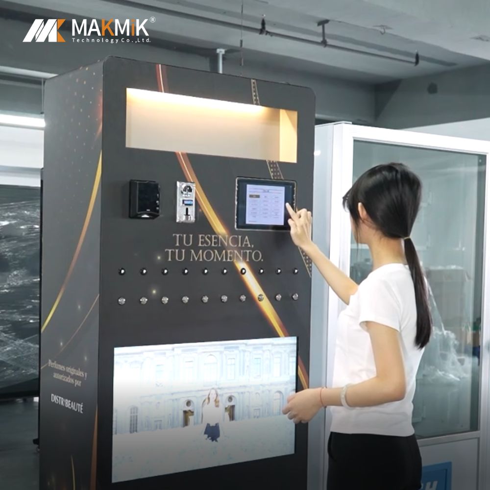 A woman touches the touchscreen during MAKMIK perfume spray and sample vending machine use.