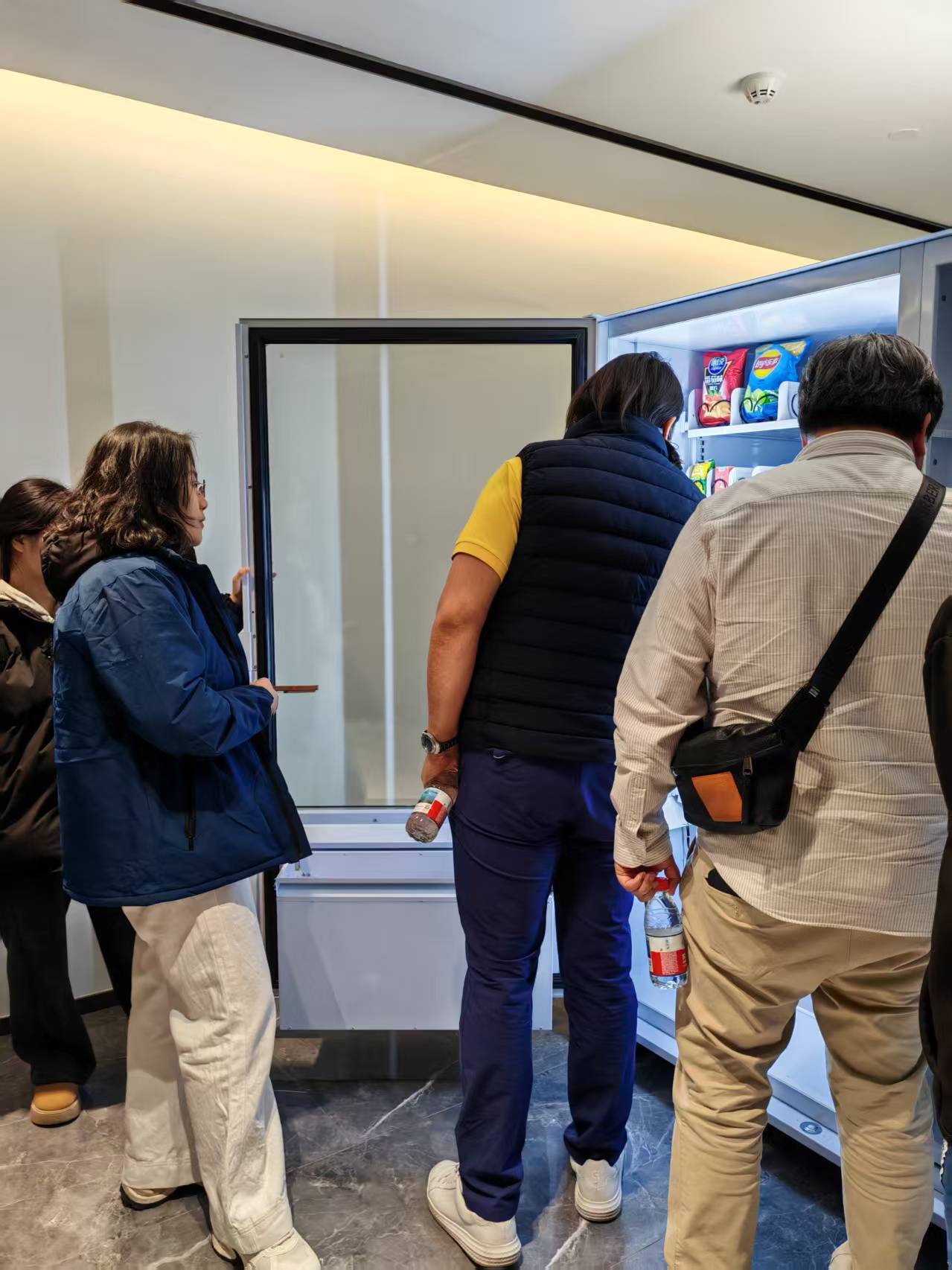 People browsing snacks in MAKMIK Factory-Direct Affordable and Durable Vending Machines.