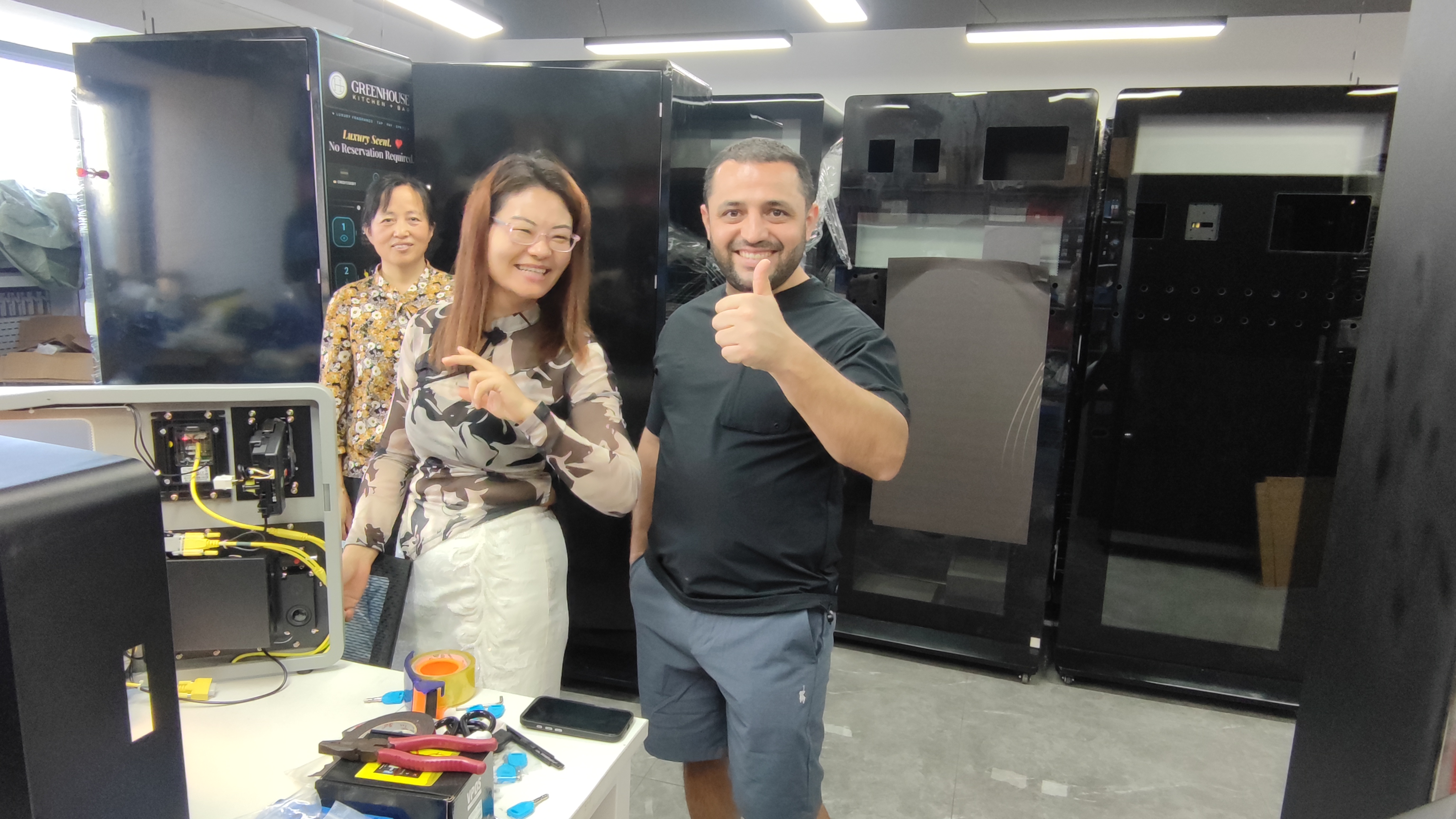 Tajik customers happily posed for a photo with their sales representatives.