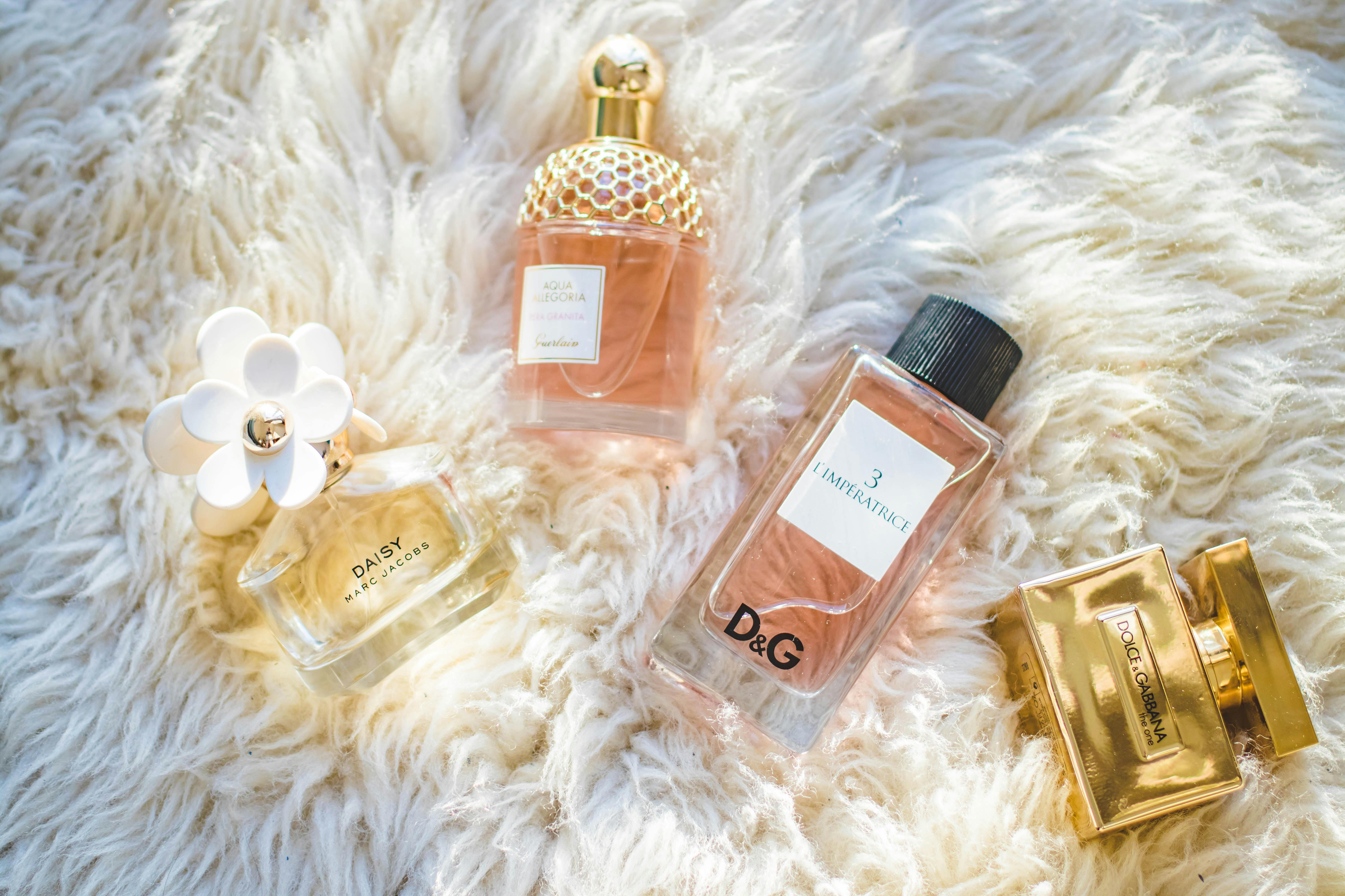 Elegant collection of perfume bottles on soft fur, highlighting luxury and style. Elegant collection of perfume bottles on soft fur, highlighting luxury and style.