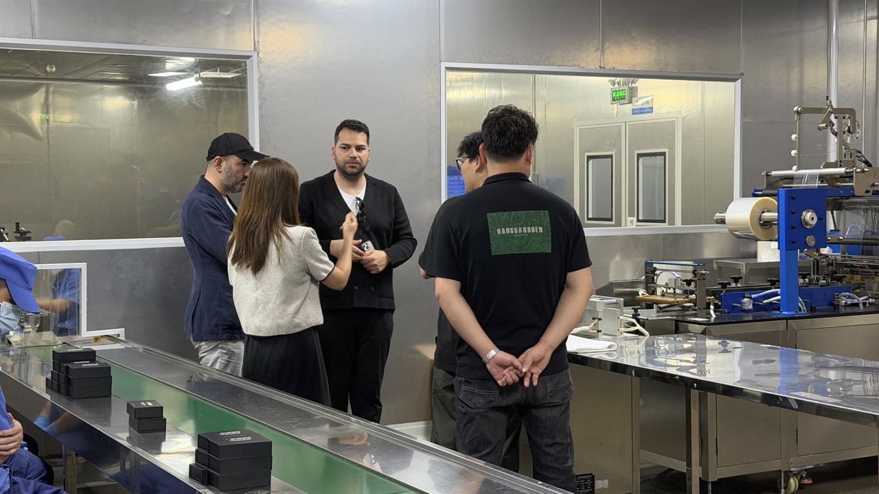 Group of people visiting a packaging assembly line in a factory. Group of people visiting a packaging assembly line in a factory.