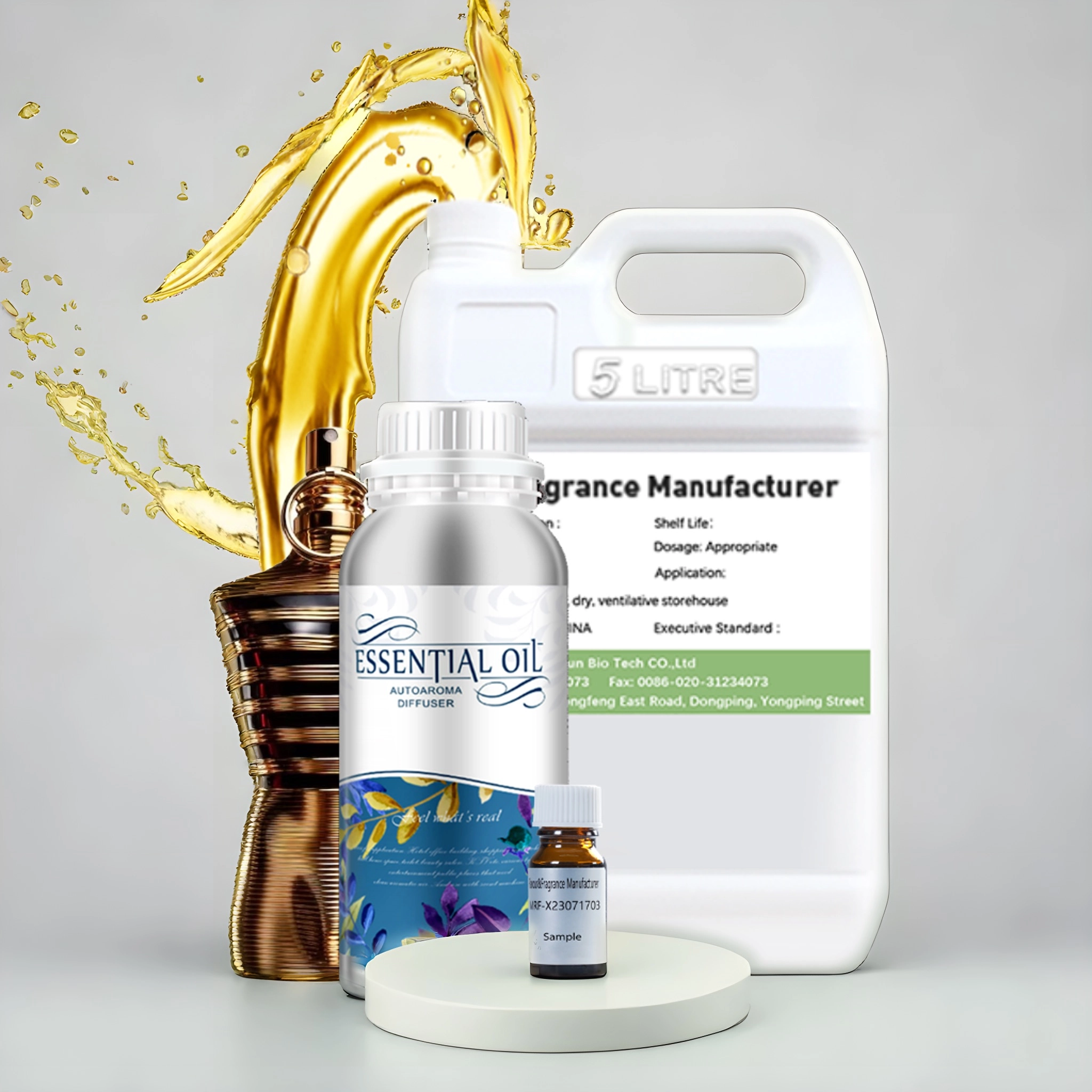 Assorted fragrance oils, including a large white jug, a silver bottle labeled "Essential Oil" and a sample bottle, are displayed on a white pedestal against a gray background with a splash of gold liquid behind them. - LEUXSCENT