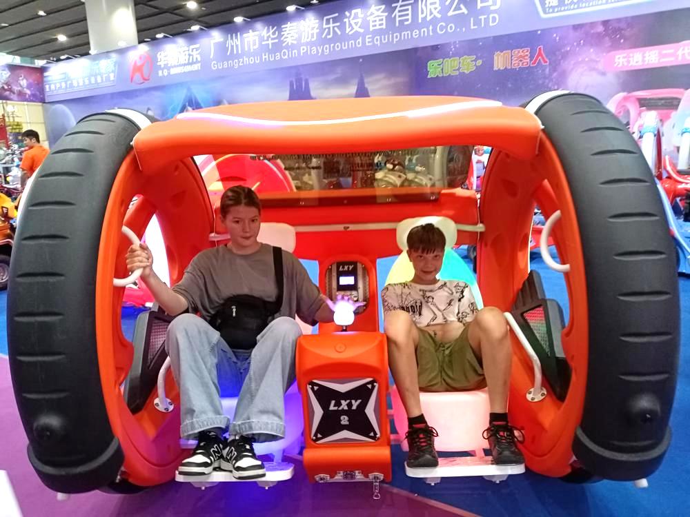 A pair of siblings experiencing the Moonwalk Car