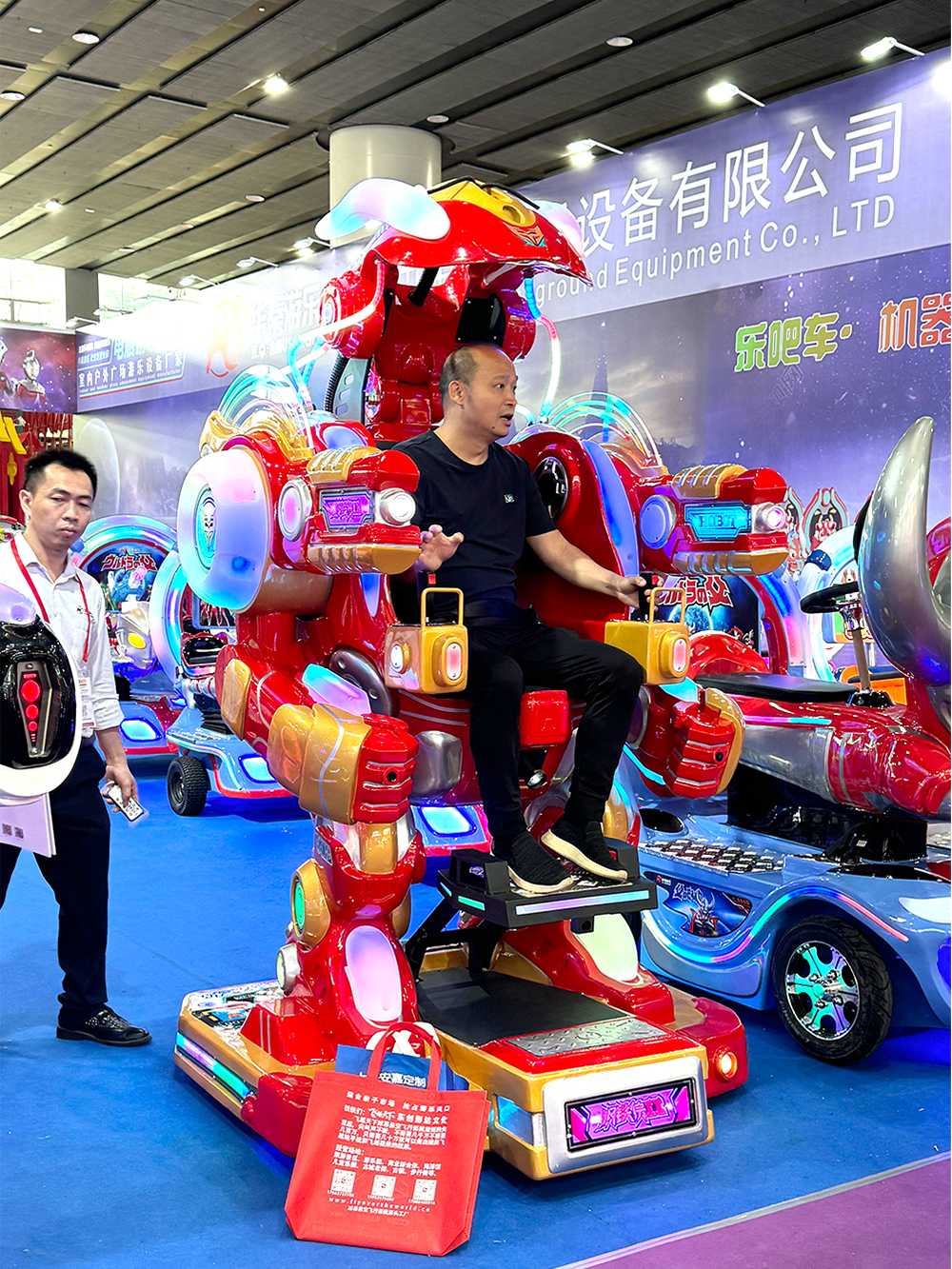 An adult male riding the Red Walking Robot