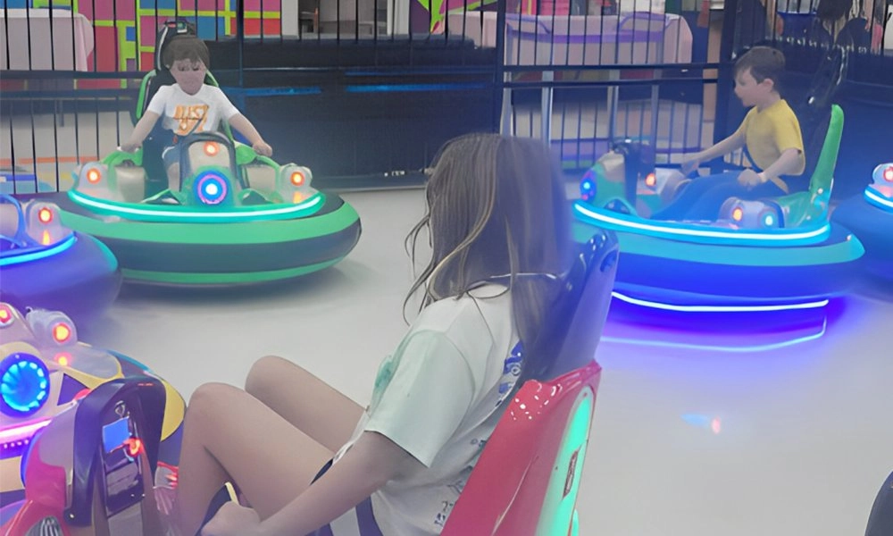 Children riding glowing bumper cars at an indoor amusement park - H.Q.Amusement