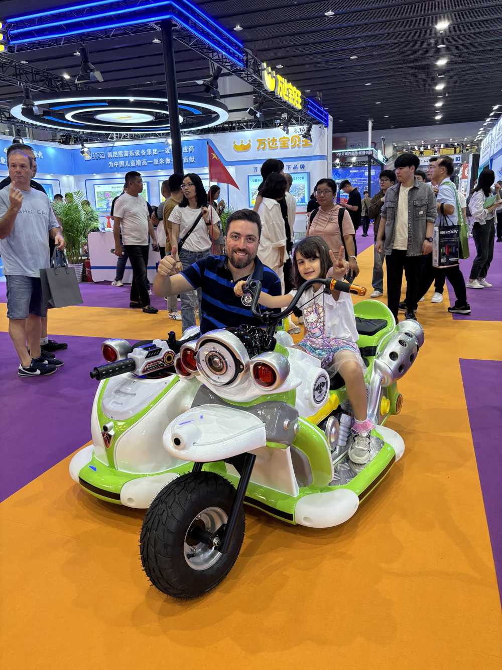 Father and daughter happily riding parent-child motorcycle with Chinese flag