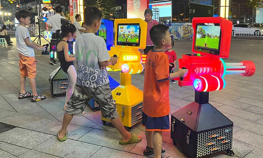 Four kids are fully engaged in playing the Sharpshooter arcade game - H.Q.Amusement