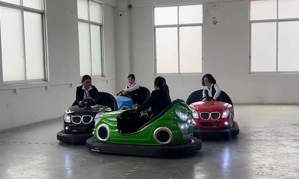 Four women riding parent-child bumper cars indoors - H.Q.Amusement