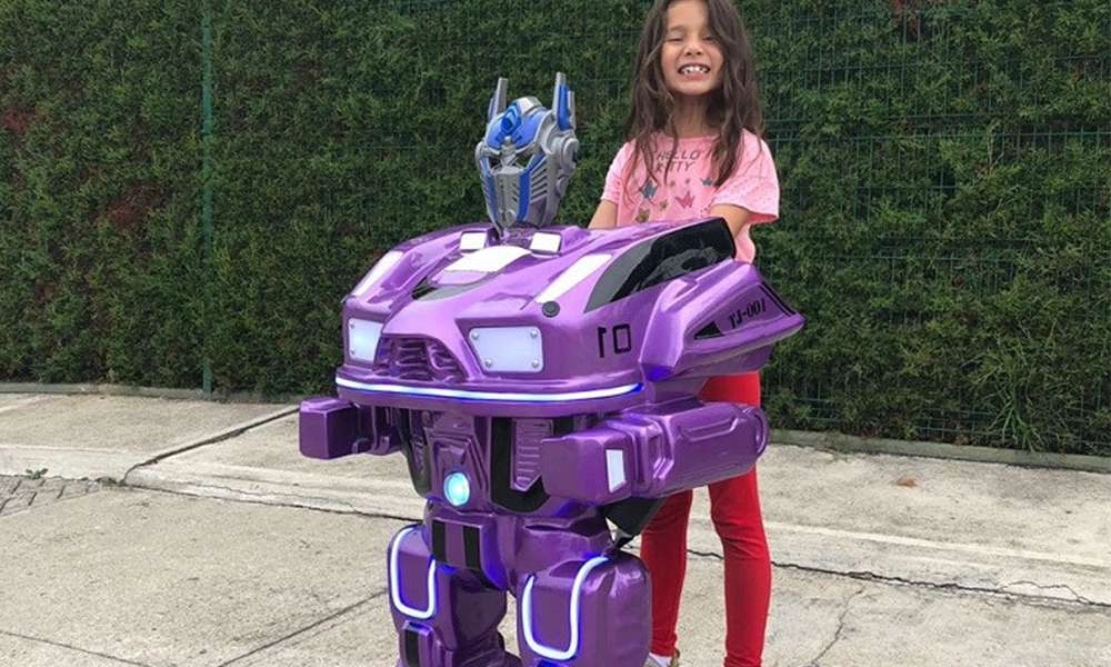 girl was smiling as she riding mini purple walking robot - H.Q.Amusement