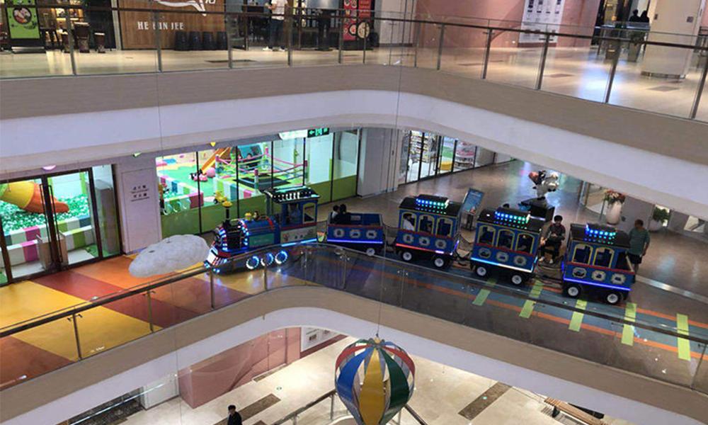 illuminated thomas trackless train with passenger in a shopping mall