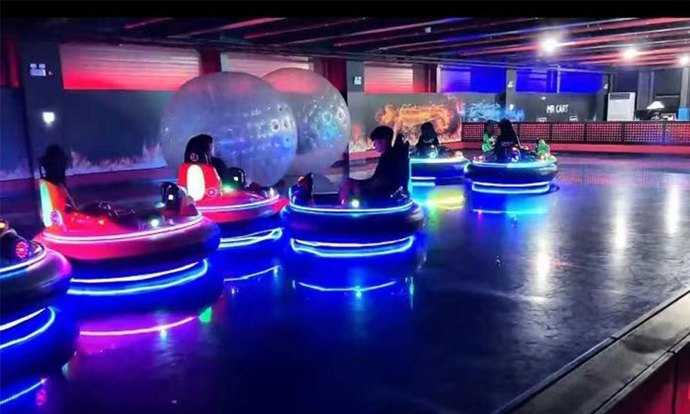Indoor bumper car arena with neon lighting and inflatable spheres - H.Q.Amusement