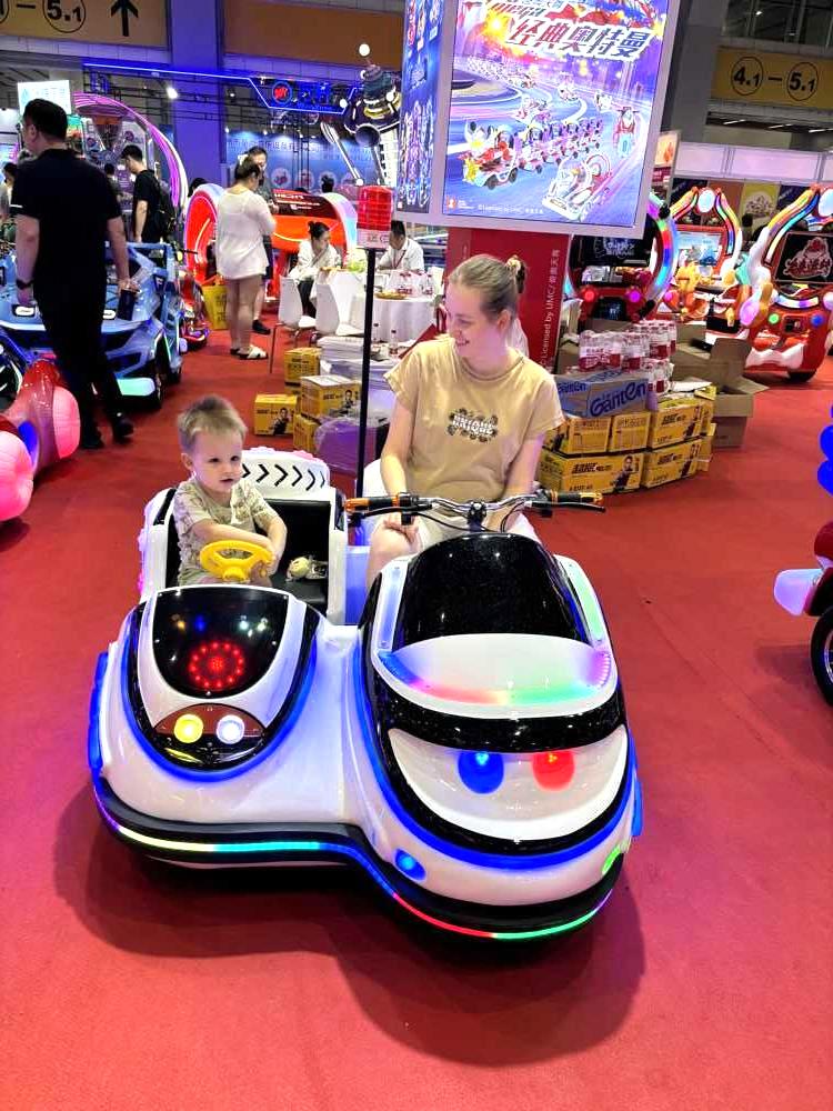 Mother and son happily riding police parent-child motorcycle with flashing lights