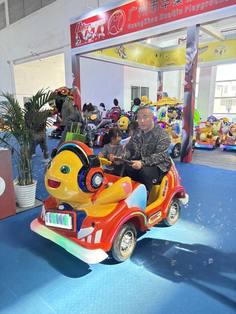 One adult riding the Nalong animal amusement ride with two young girls