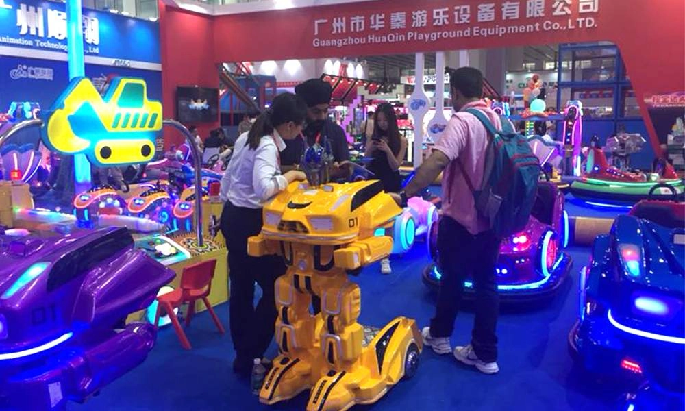 People looking at the Guangzhou HUAQIN Playground Equipment Co., LTD booth with their walking robots at trade show - H.Q.Amusement