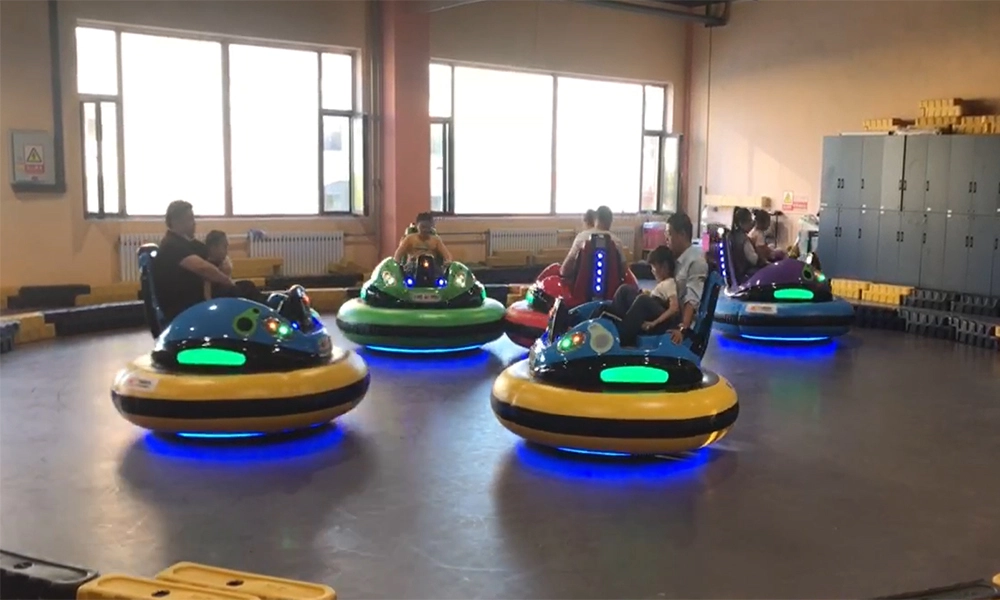 People riding colorful bumper cars in an indoor amusement park - H.Q.Amusement