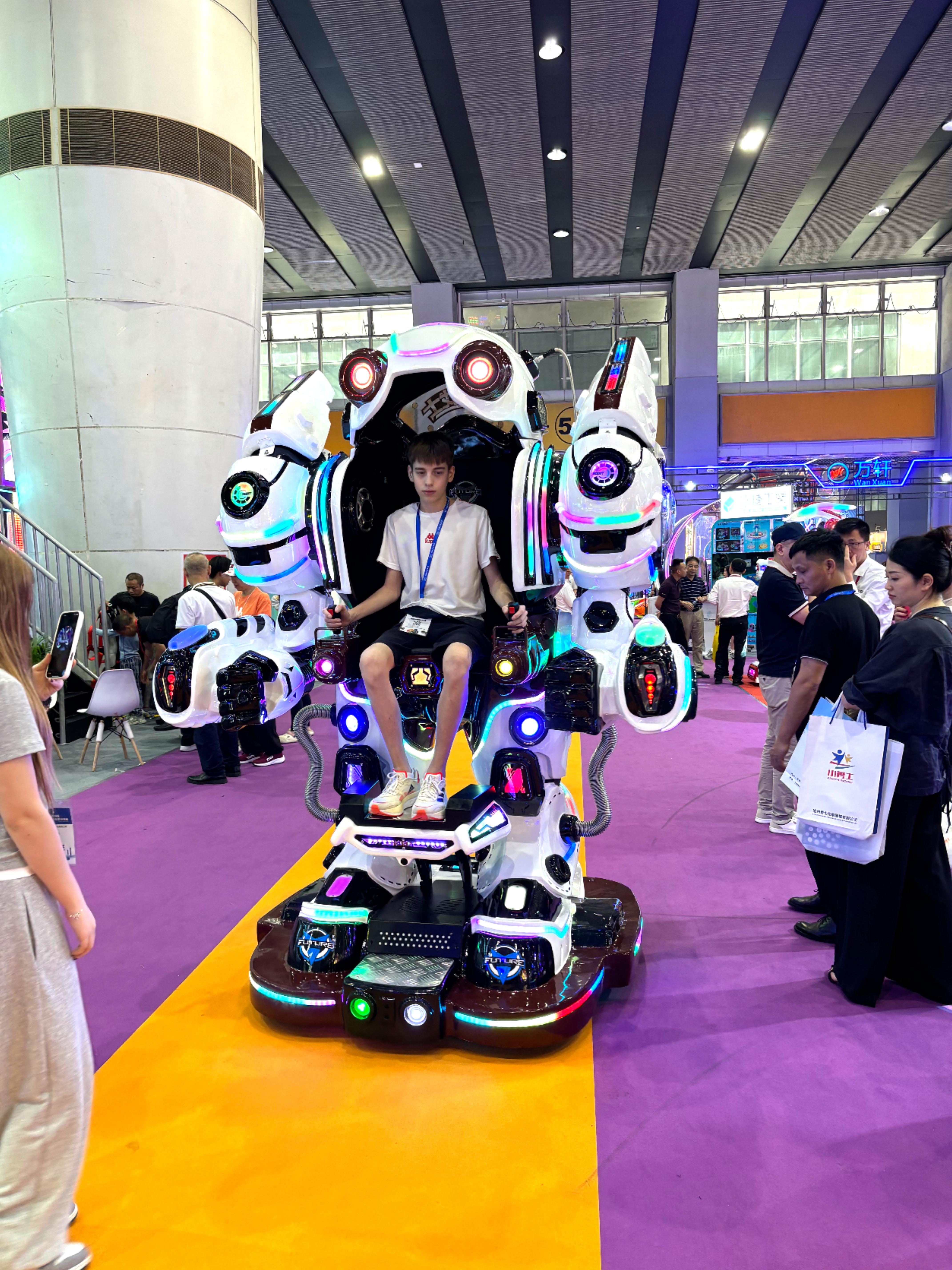 Teen boy playing Future Warrior robot ride