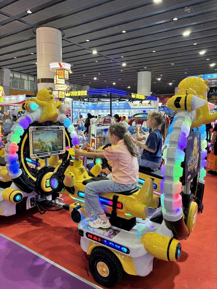 Two girls playing screen game on Nailong trackless train