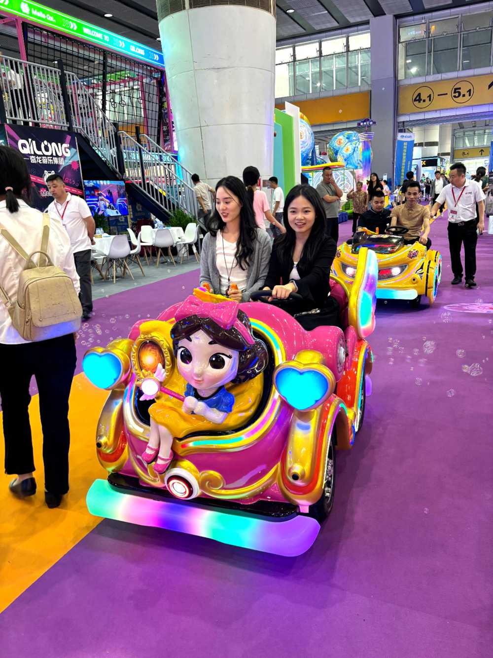 Two girls riding Magic Princess kiddie ride together