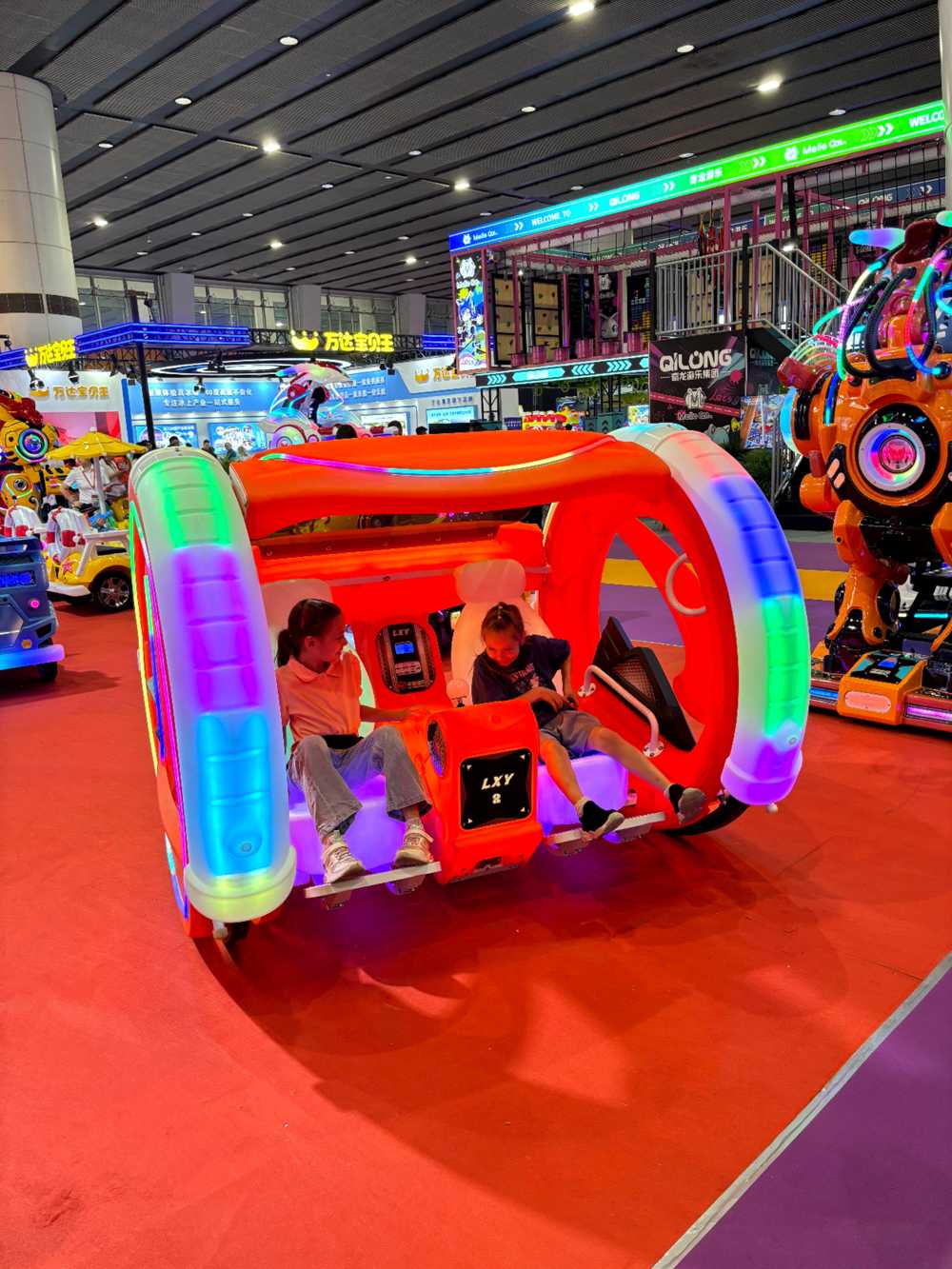 Two girls riding Moonwalk Car together