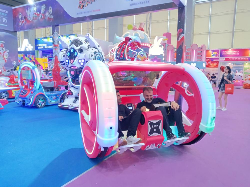 Two male friends experiencing the Pink Moonwalk Car