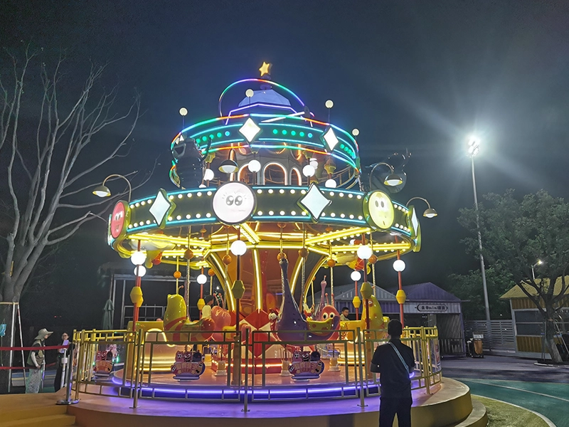 Carrusel de dos pisos Larva de 16 asientos que brilla por la noche en un parque de atracciones