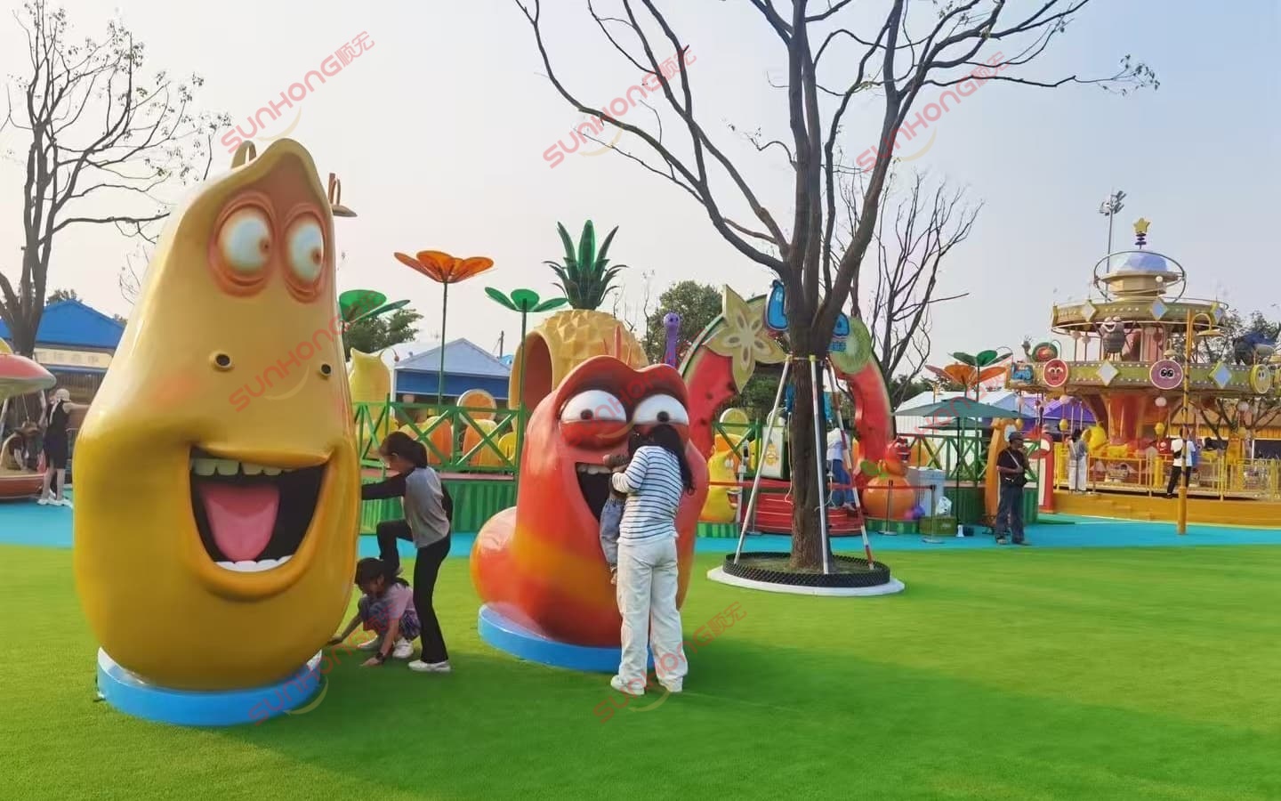 Kids playing around Larva cartoon character sculptures in an outdoor amusement park. Kids playing around Larva cartoon character sculptures in an outdoor amusement park.