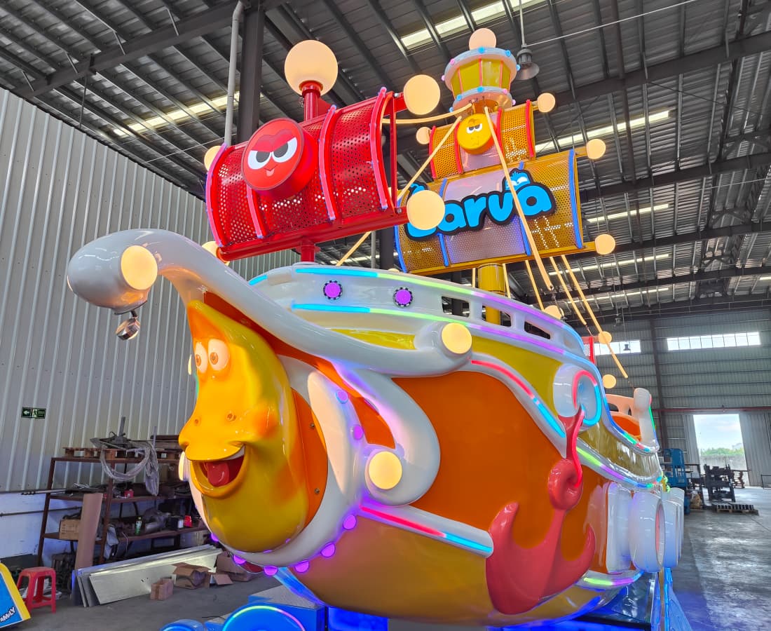 Front close-up of the Larva Drifting pirate ship, featuring the 'Little Yellow' character on the bow and a red sail, designed for pirate ship theme parks. - SUNHONG
