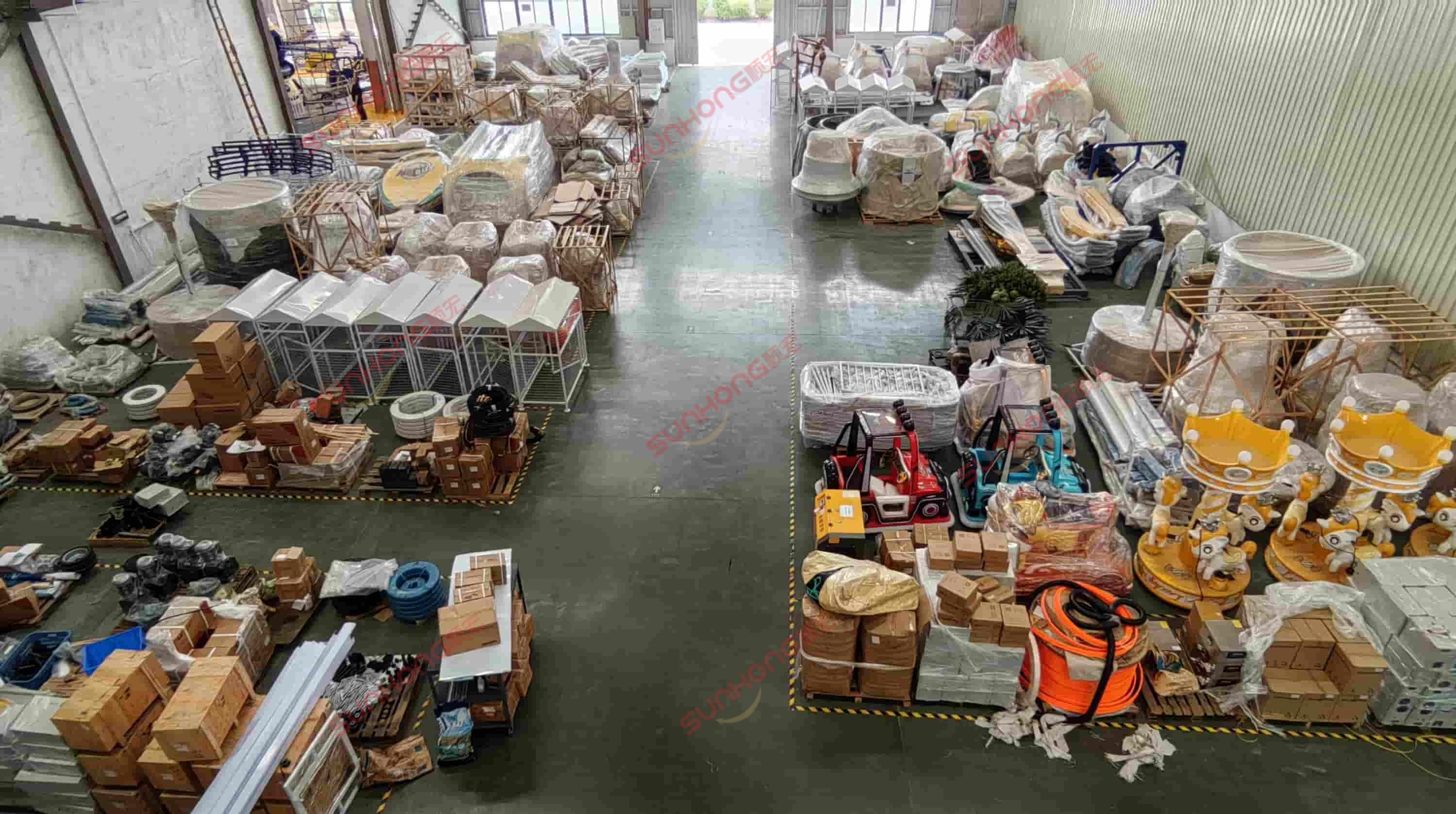 amusement-equipment-warehouse-storage - SUNHONG Neatly organized ride components and packaging materials in the warehouse section of an amusement equipment manufacturing factory. - SUNHONG