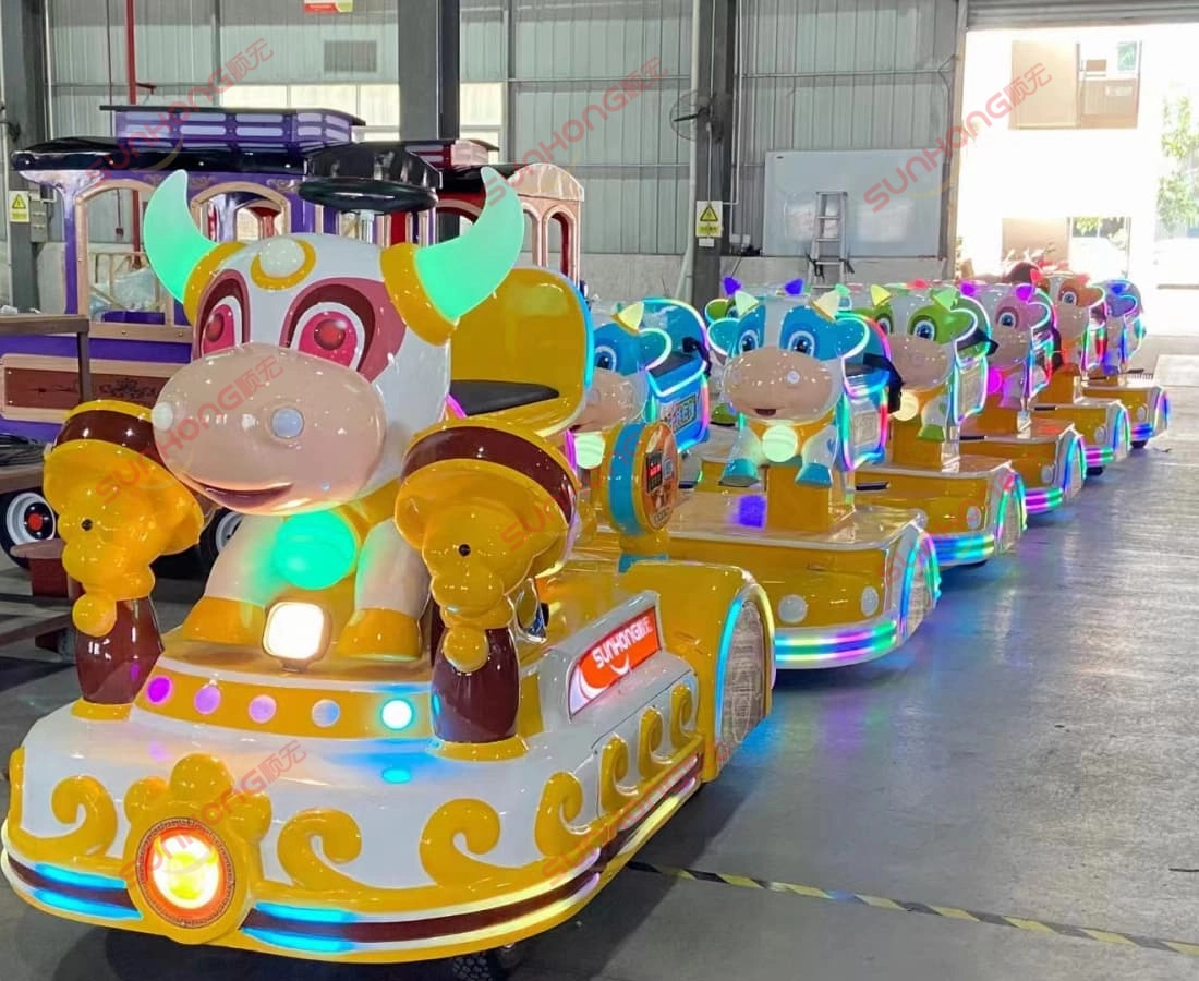 bull-train-front-view-storage-small-trains-for-parks - SUNHONG Front view of Bull Train lineup with LED lights in warehouse, ideal small trains for park operations - SUNHONG